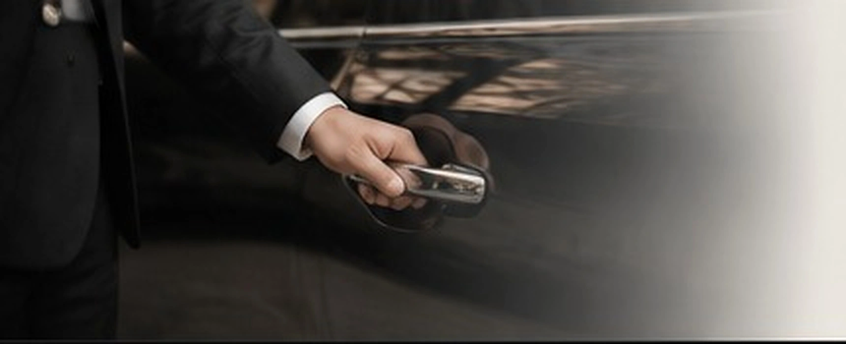 Professional chauffeur opening a luxury vehicle door